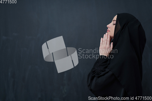 Image of Portrait of young Muslim woman making dua