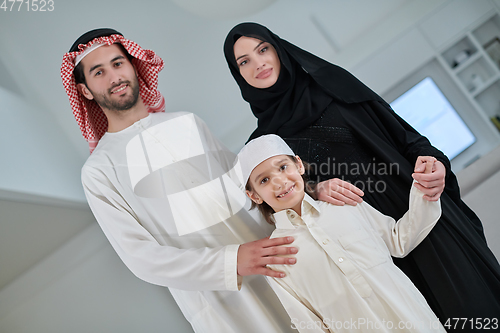 Image of Portrait of young arabian muslim family wearing traditional clothes