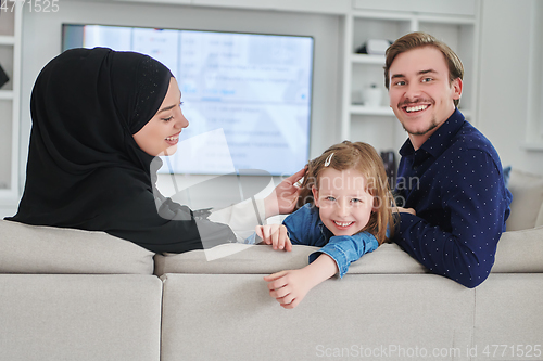 Image of Happy Muslim family spending time together in modern home