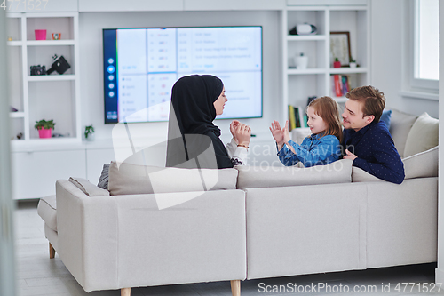 Image of Happy Muslim family spending time together in modern home