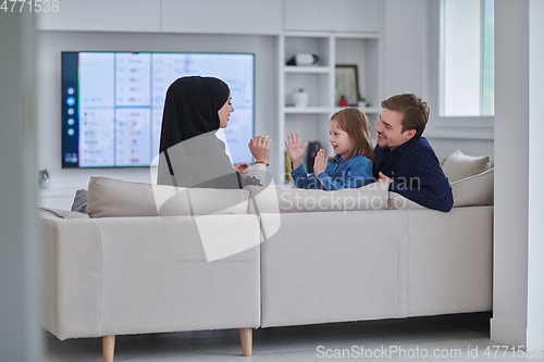 Image of Happy Muslim family spending time together in modern home