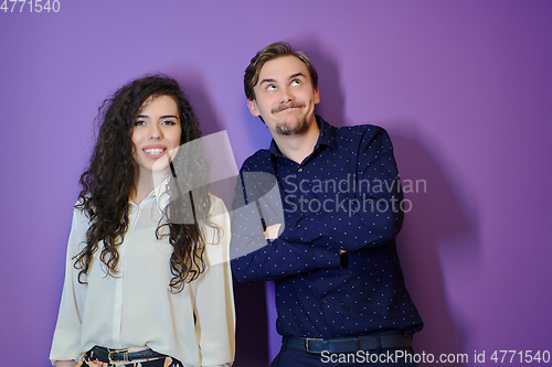 Image of Happy young couple posing on purple background