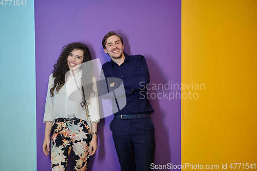 Image of Happy young couple posing on purple background