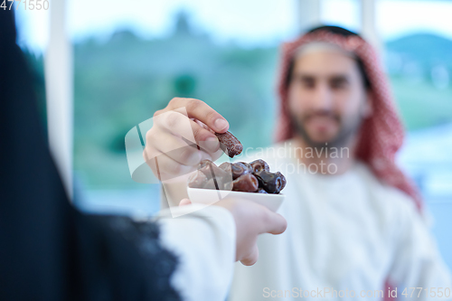 Image of Muslim couple sharing dates for starting iftar