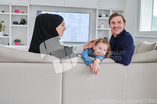 Image of Happy Muslim family spending time together in modern home