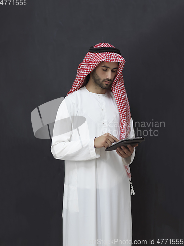 Image of Portrait of young muslim businessman using tablet