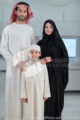 Image of Portrait of young arabian muslim family wearing traditional clothes