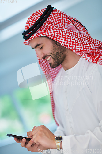 Image of Portrait of young muslim businessman using mobile phone