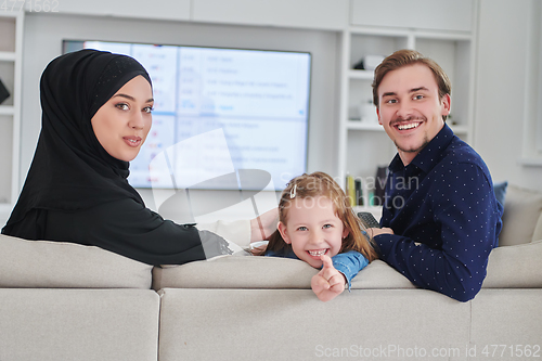 Image of Happy Muslim family spending time together in modern home