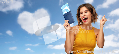 Image of happy young woman with air ticket and passport