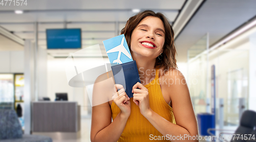 Image of happy young woman with air ticket at airport
