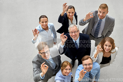 Image of business people showing ok hand sign at office