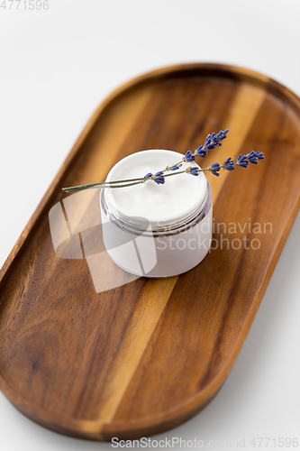 Image of close up of lavender moisturizer on wooden tray
