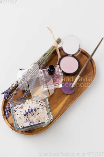 Image of sea salt, perfume and lavender on wooden tray