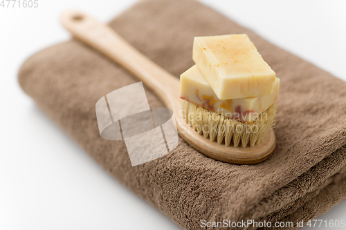 Image of crafted soap bars, natural brush and bath towel