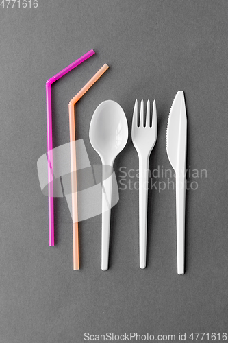 Image of disposable plastic fork, knife, spoon and straws