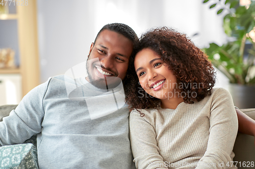 Image of happy african american couple on sofa at home