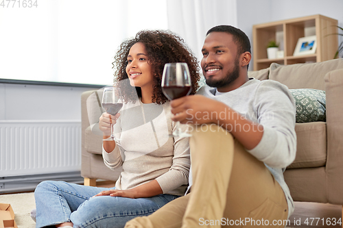 Image of african american couple drinking wine at home