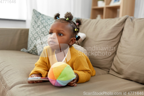 Image of african american baby girl with smartphone at home