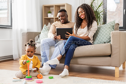 Image of family with tablet pc and toy blocks at home