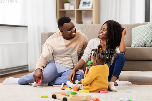 Image of african family playing with baby daughter at home