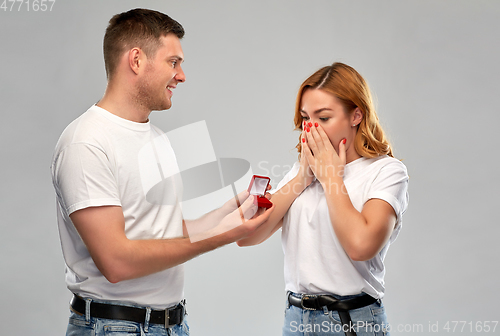 Image of man giving woman engagement ring on valentines day