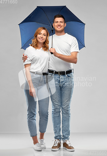 Image of happy couple in white t-shirts with umbrella