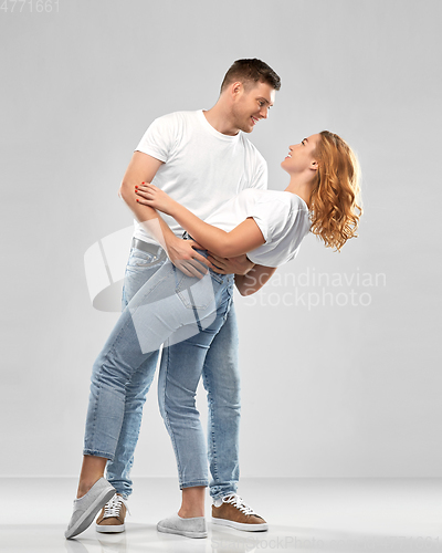 Image of portrait of happy couple in white t-shirts dancing