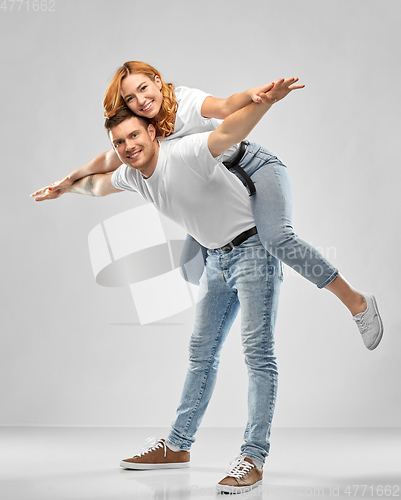 Image of happy couple in white t-shirts having fun