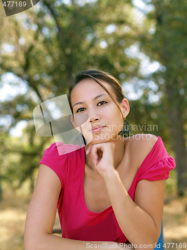 Image of Young asian american woman portrait outdoors pink top