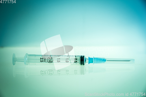 Image of Syringe on blue background