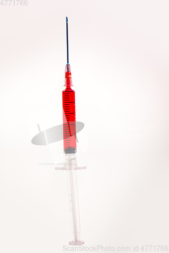 Image of Syringe with blood on white background