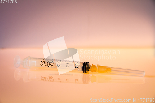 Image of Syringe on orange background