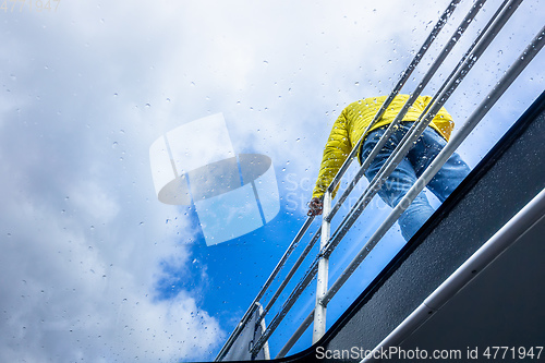 Image of rainy day tour man at a railing