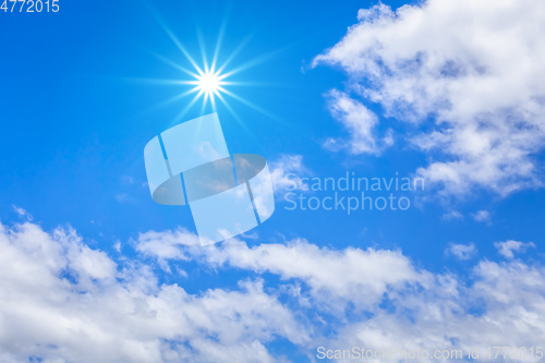 Image of blue sky with hugh white clouds and sun background
