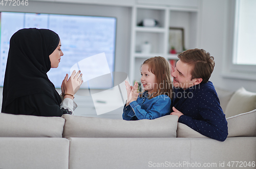 Image of Happy Muslim family spending time together in modern home