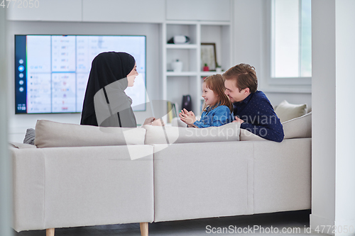 Image of Happy Muslim family spending time together in modern home