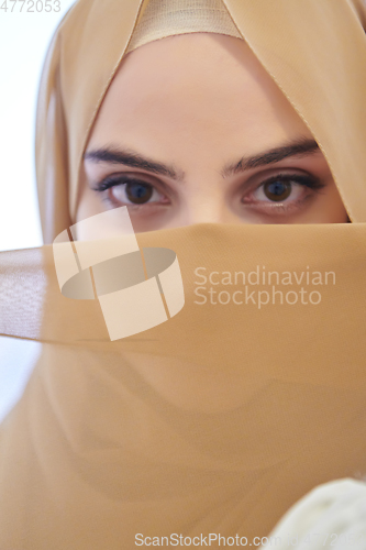 Image of Portrait of young girl with niqab on face