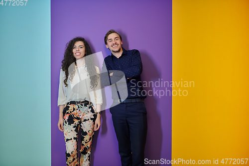 Image of Happy young couple posing on purple background