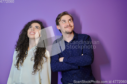 Image of Happy young couple posing on purple background