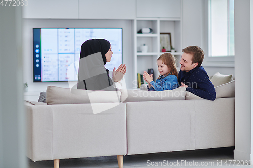 Image of Happy Muslim family spending time together in modern home