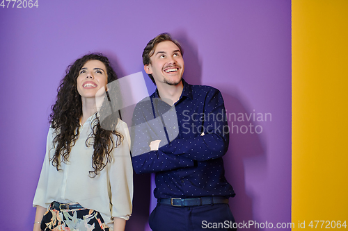Image of Happy young couple posing on purple background