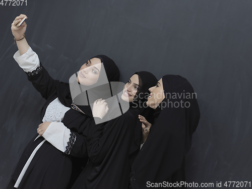 Image of Portrait of Arab women wearing traditional clothes or abaya taking selfie