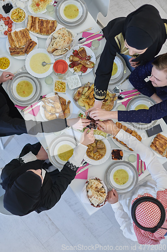 Image of Top view of muslim family having Iftar during Ramadan holy month