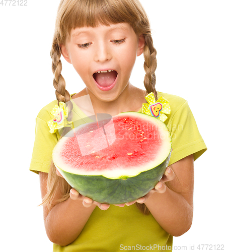 Image of Little girl is eating watermelon
