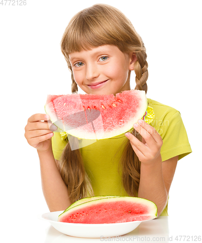 Image of Little girl is eating watermelon