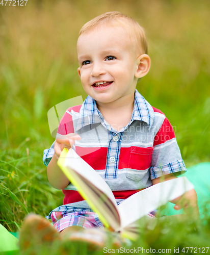 Image of Little boy is reading book