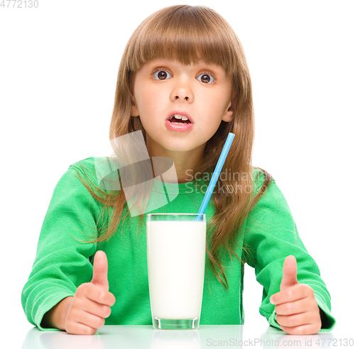 Image of Cute little girl with a glass of milk