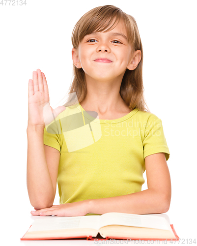 Image of Little girl is rising her hand up