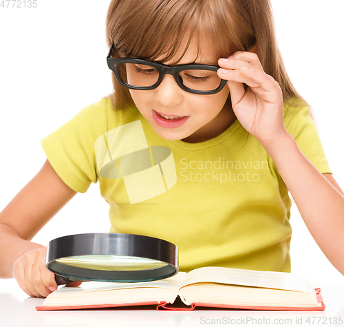 Image of Little girl is reading book